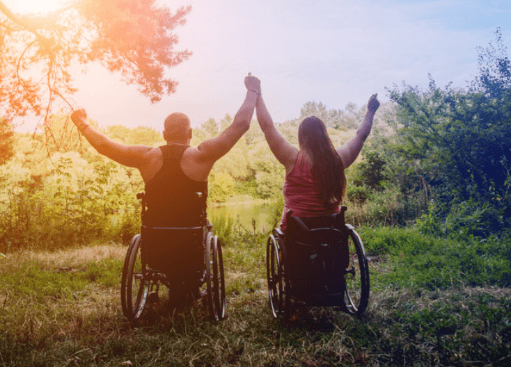 two people in wheelchairs feeling freedom and achievement
