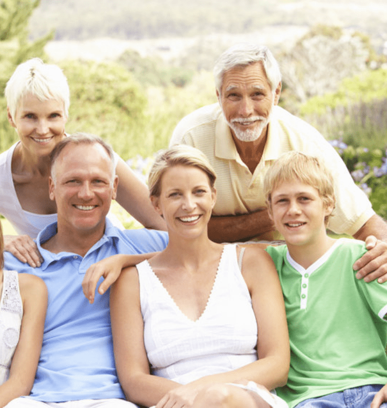 grandparents with family smiling outside