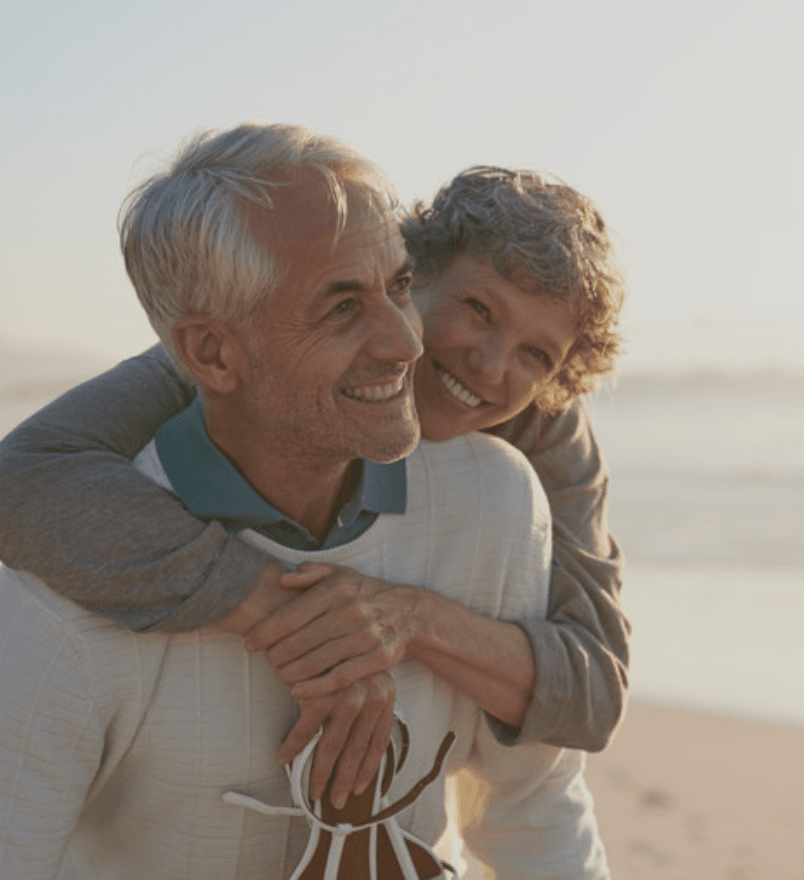 elderly couple hugging one another