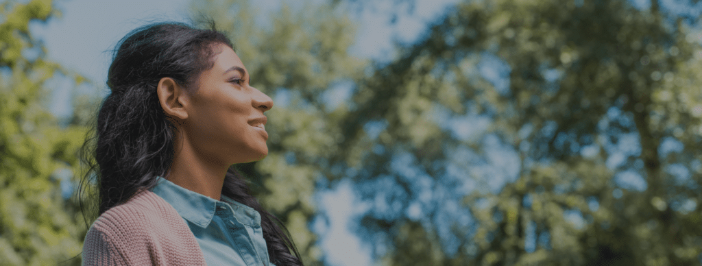 relieved and happy woman outside smiling