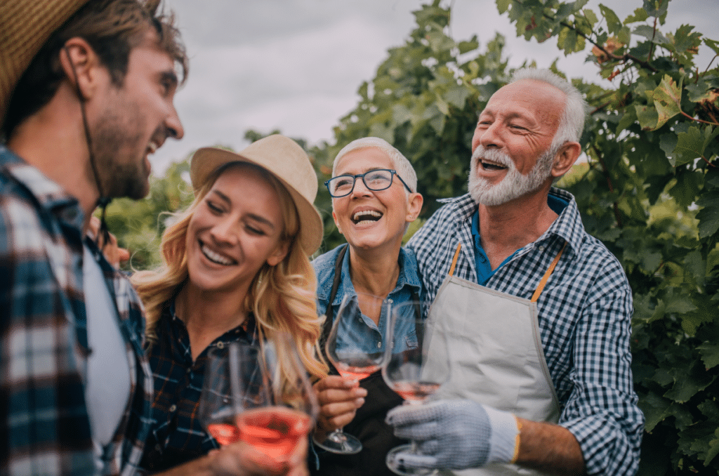 elderly couple drinking wine and laughing together