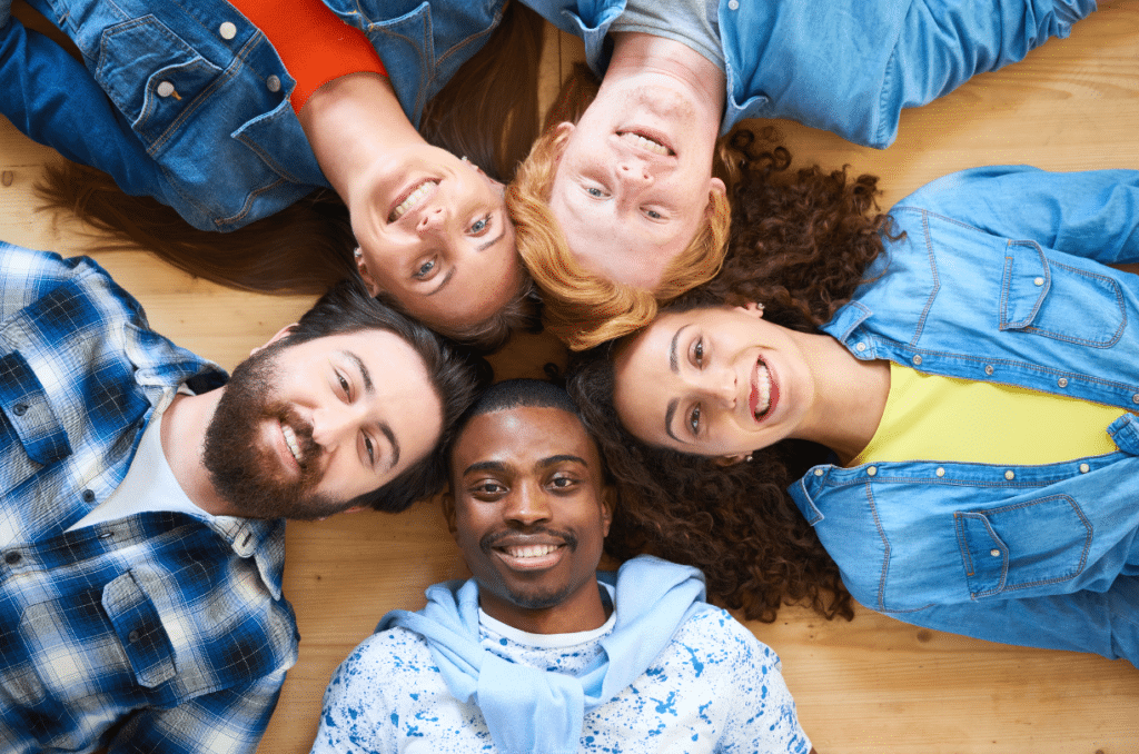 group of people laying down smiling