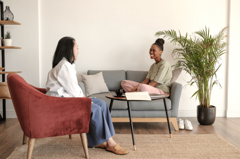 happy client sitting on couch while therapist listens