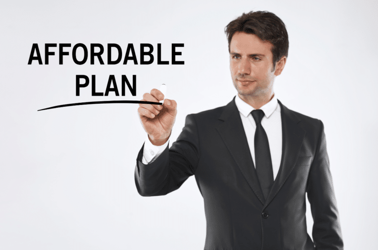 serious man in suit man drawing "affordable plan" on glass