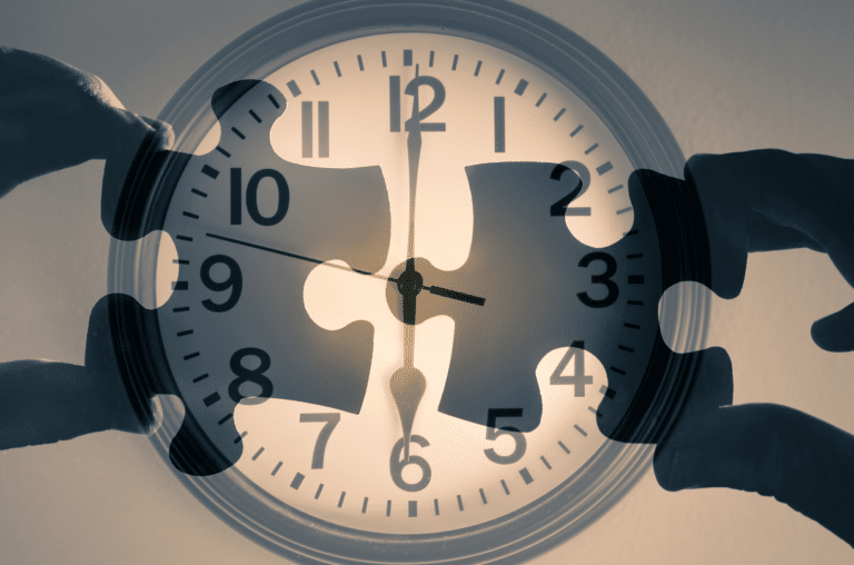 two puzzle pieces being connected with a clock in the background