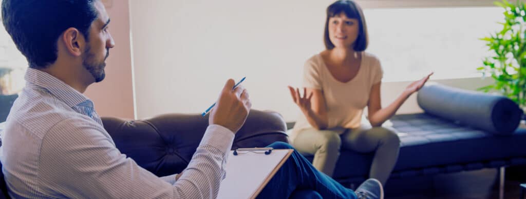 woman client talking to male therapist