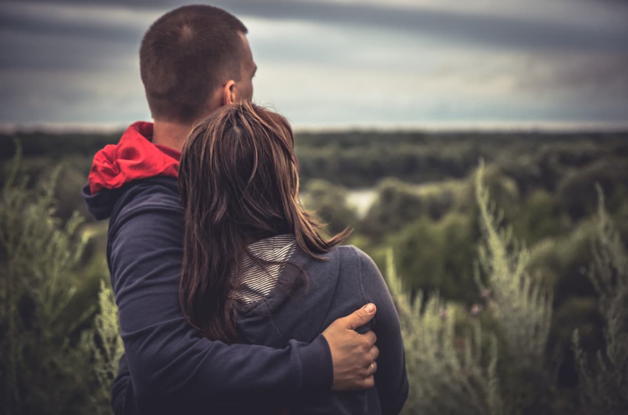 woman and man hugging outside