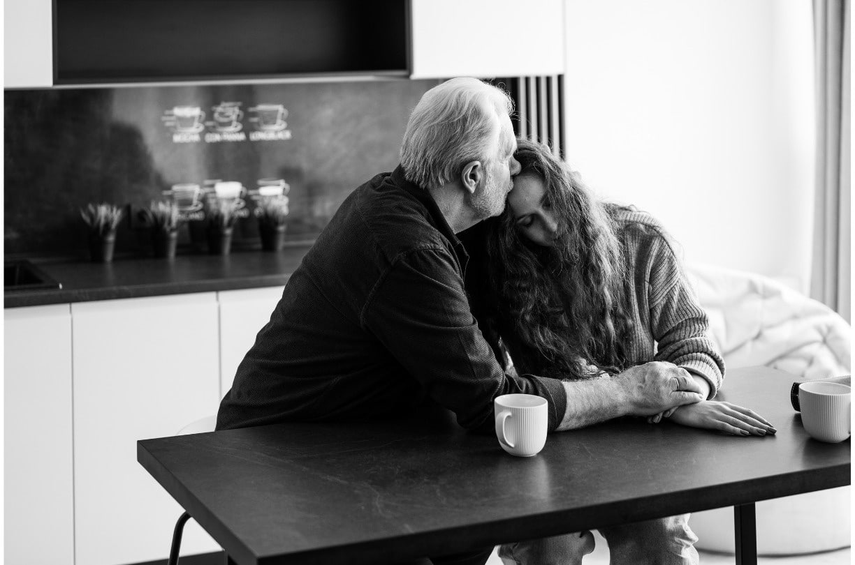 woman laying her head on a man's shoulder