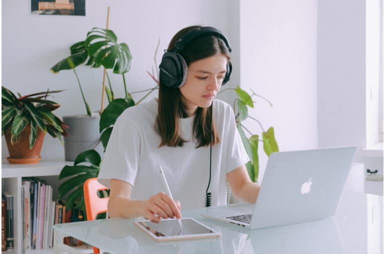teenager listening to music in headphones on computer