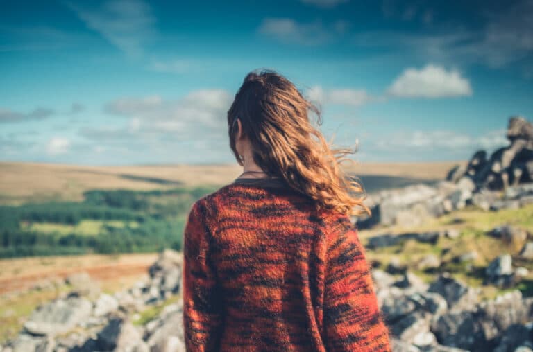 woman looking into landscape of mountains