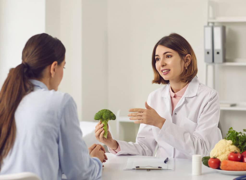 healthcare professional talking to woman about vegetables