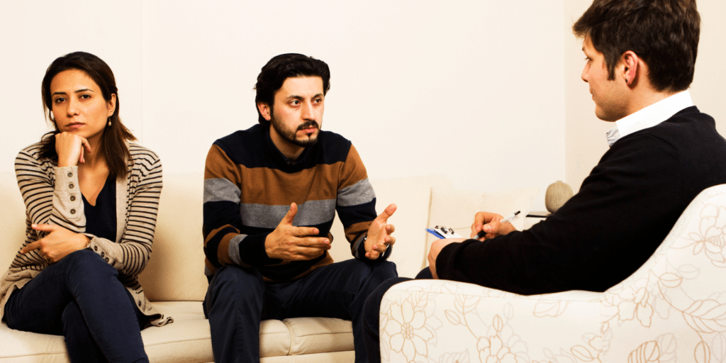 couple with hardships talking to therapist