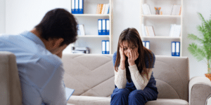 woman crying on couch in therapy