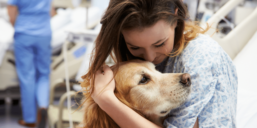 woman hugging a therapy dog