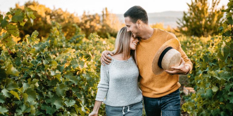 man hugging his wife outside in a field