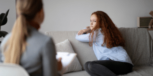woman listening to therapist with a confused sad face