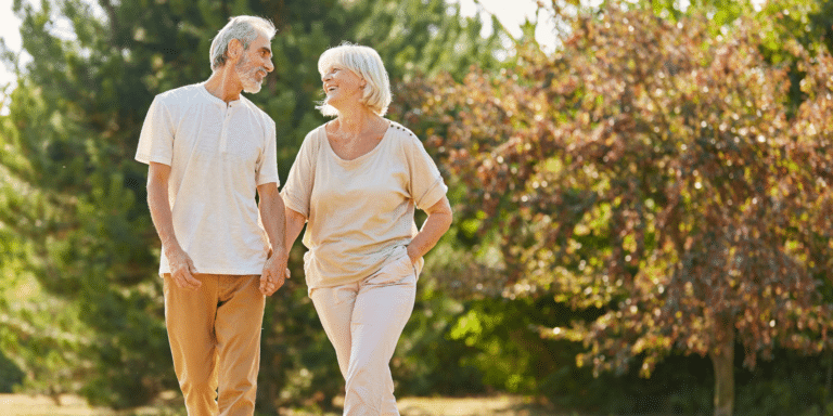 happy elderly couple taking a walk outside