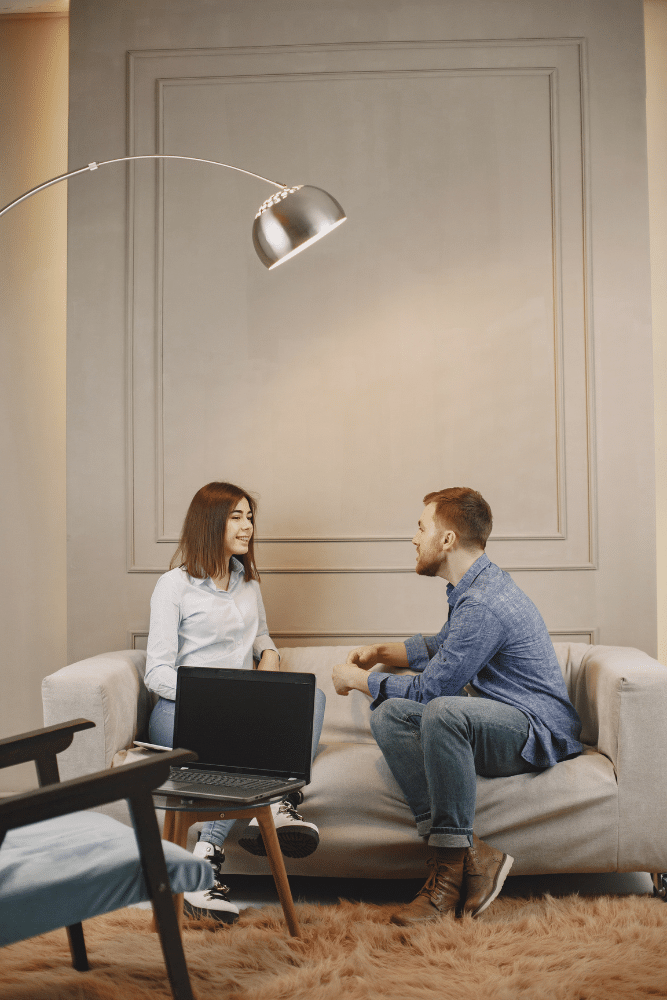man and a woman therapist talking together on a couch