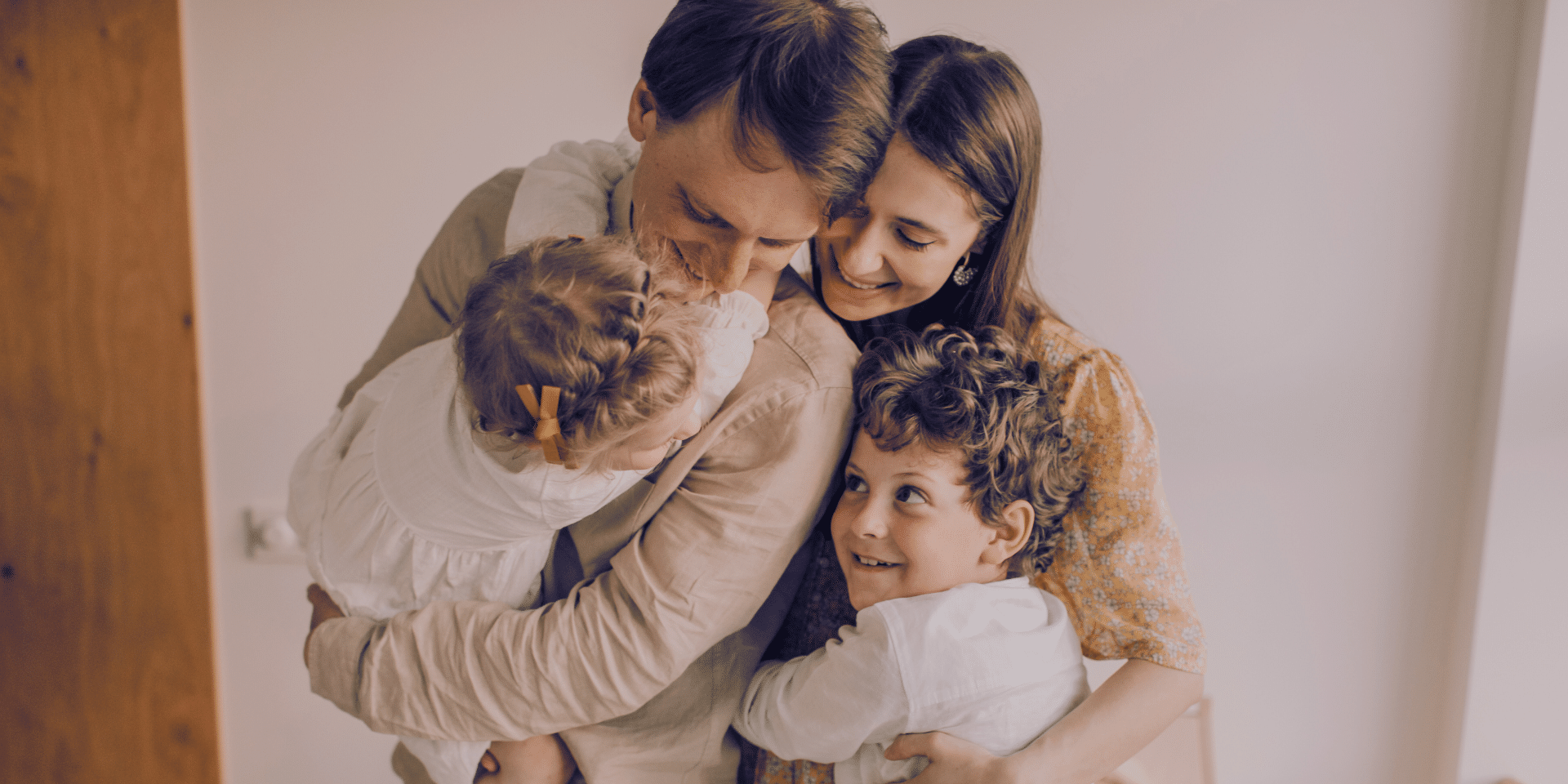 family hugging each other and smiling after a therapy session