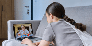 teenage girl on a virtual call with her therapist