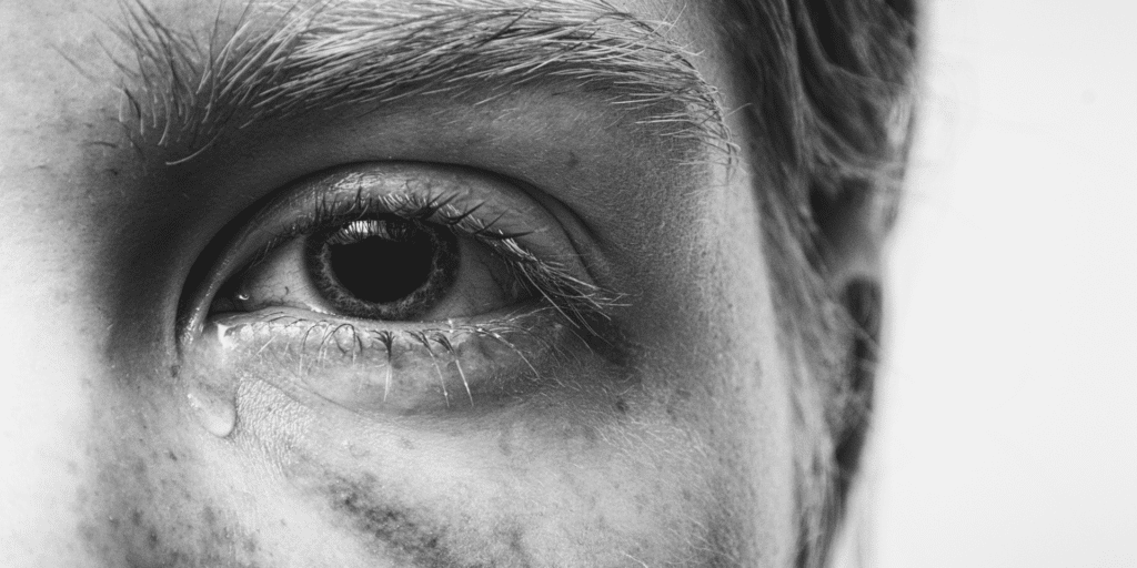 close up of a persons eye crying, sadness and needing counseling from a therapist