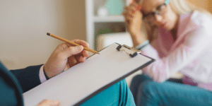 therapist taking notes of client during session
