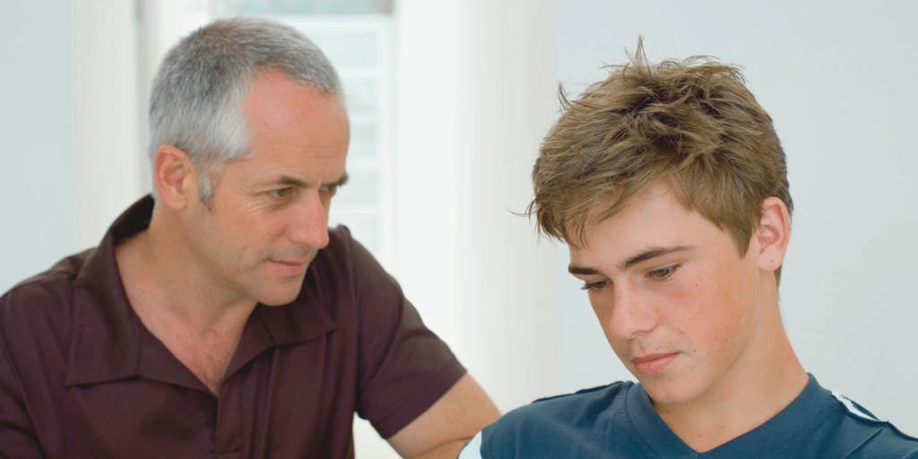 older male counselor talking to his disappointed teenage client in therapy