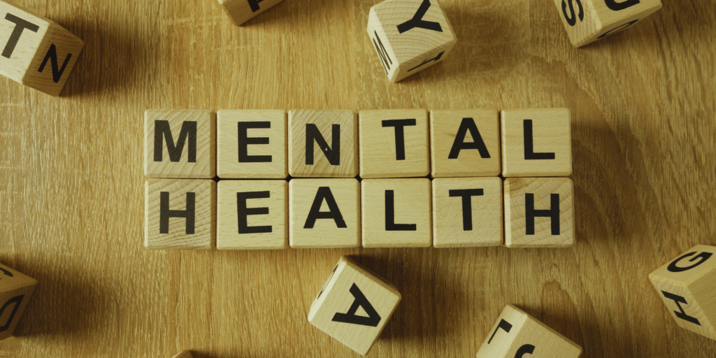 "mental health" wooden cubes laid out on a table