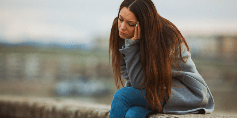 Person experiencing depression seeking therapy and support in Denver