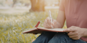 Person journaling as part of therapy and mental wellness in Denver, Colorado