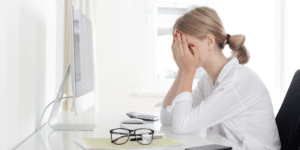 Stressed woman experiencing anxiety and burnout seeking therapy in Denver