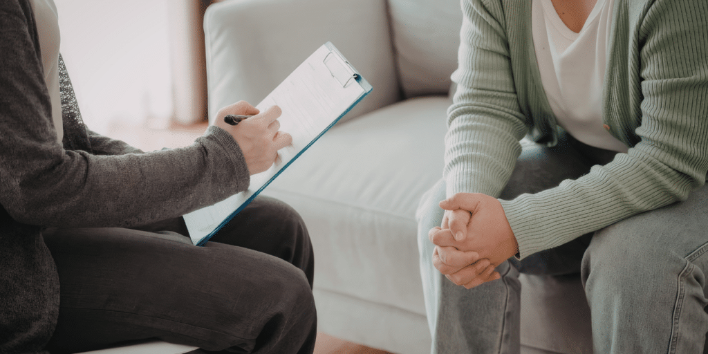 Licensed therapist taking notes during a counseling session in Denver
