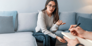 Woman in therapy counseling session with a licensed therapist in Denver