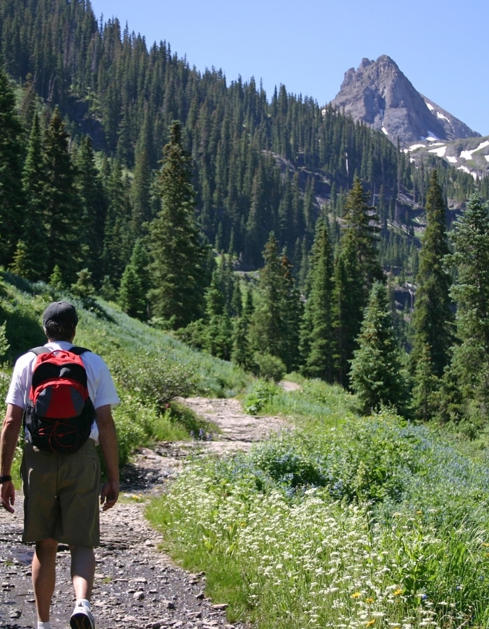 Hiker walking a Colorado mountain trail, representing nature, mindfulness and mental health